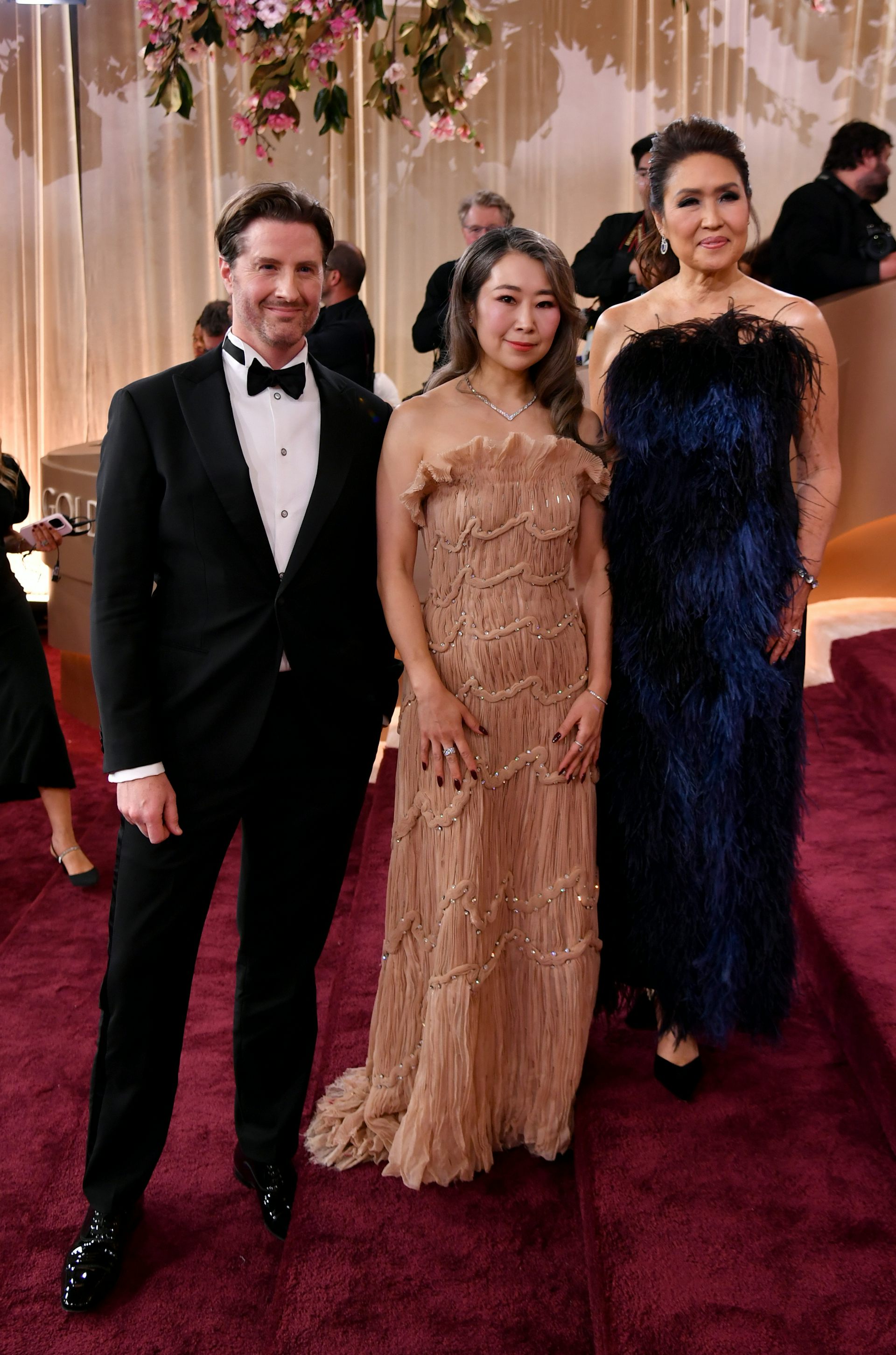 A man and two women in dressy clothes.