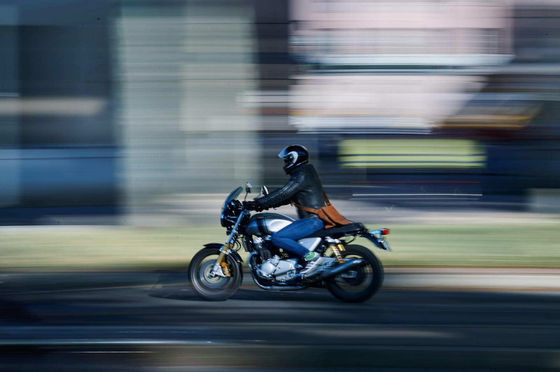 A motorcyclist against a blurred background.