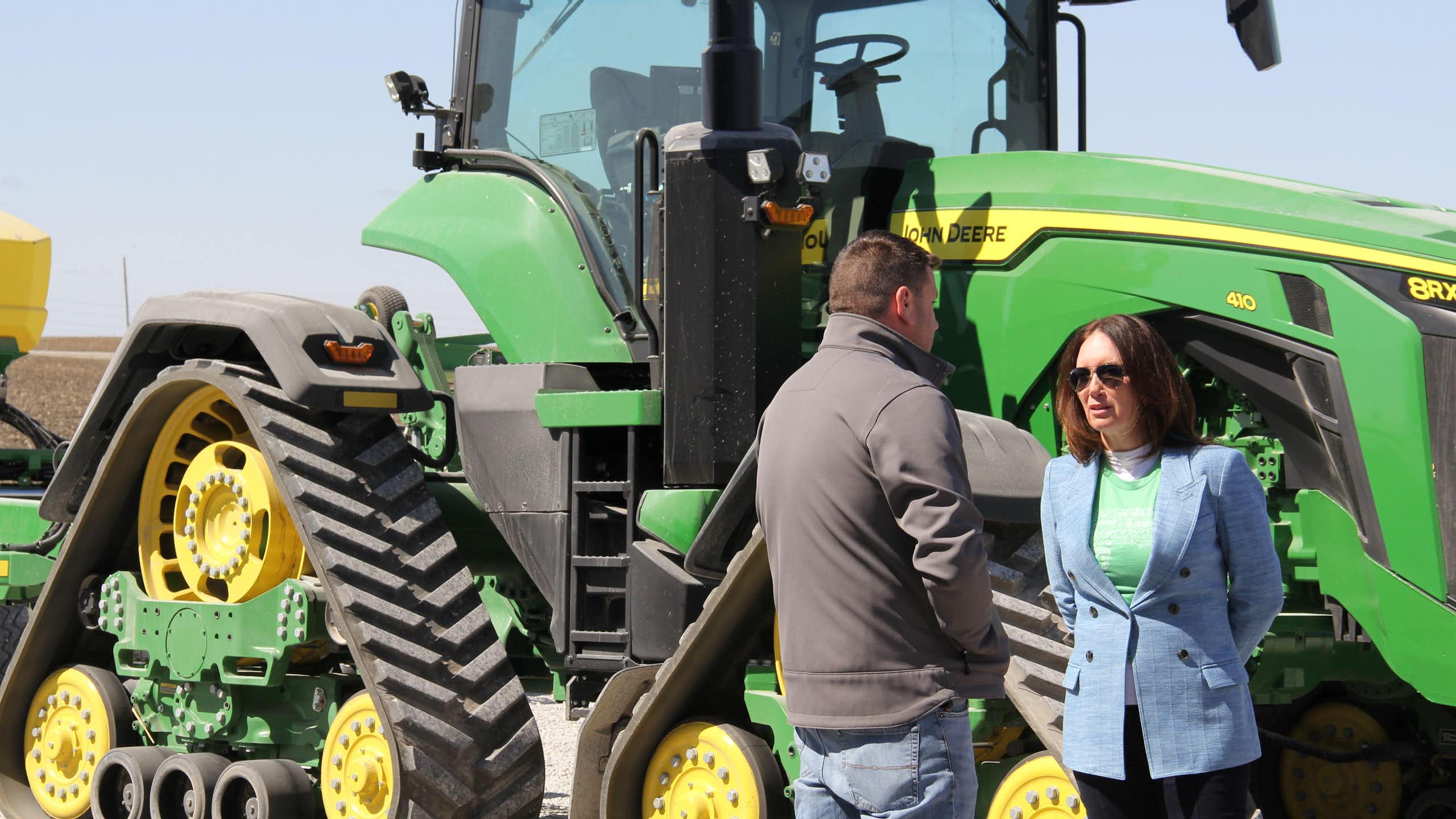 US agriculture secretary, Brooke Rollins, talks to a pig farmer in Iowa in front of his tractor, March 2025.