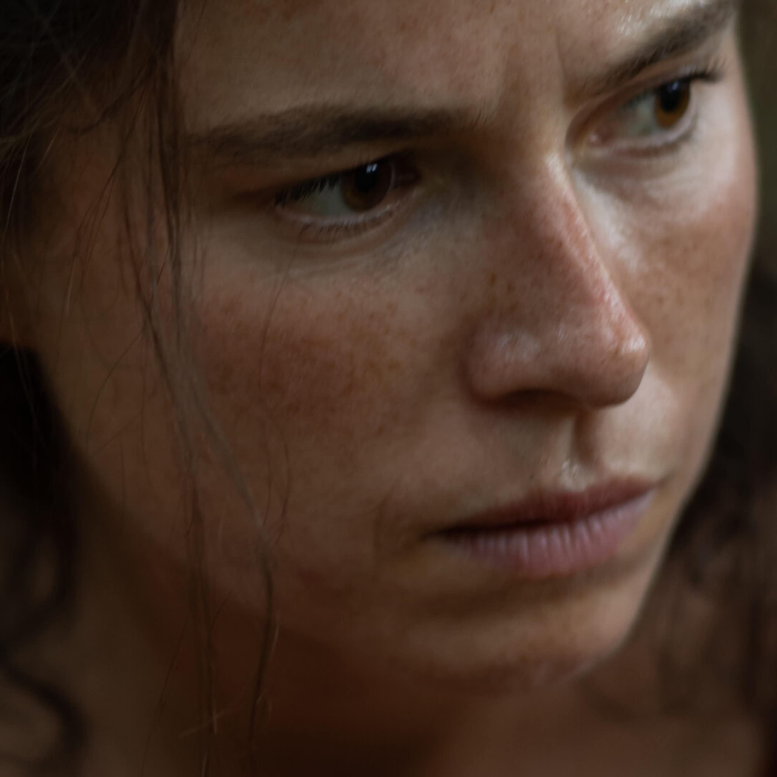 A woman stares pensively.