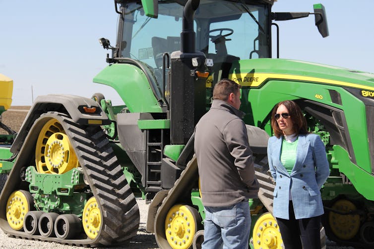 Trump’s Board of Peace launches right into a warring international 1 US agriculture secretary, Brooke Rollins, talks to a pig farmer in Iowa in front of his tractor, March 2025.