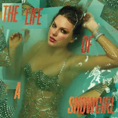 Image of a woman looking up from a greeny blue setting suggesting water in a jeweled bustier.