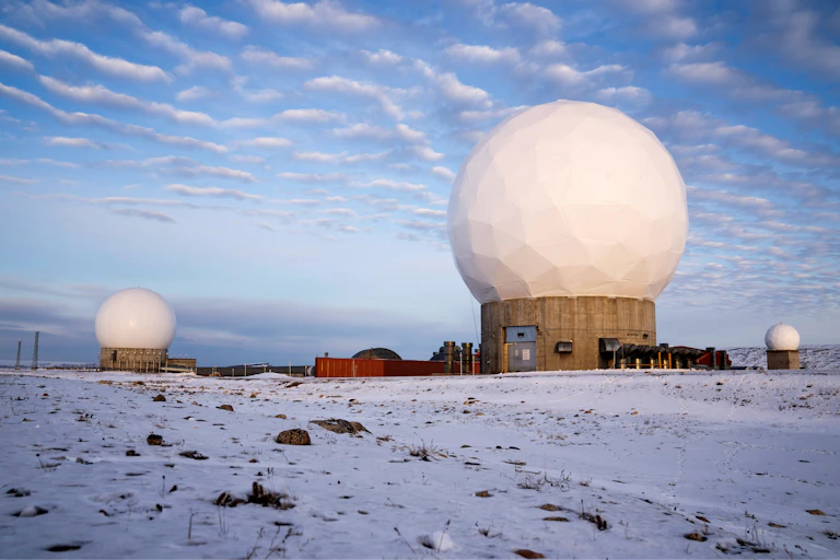 Satellite monitoring domes in Greenland's icey landscape.