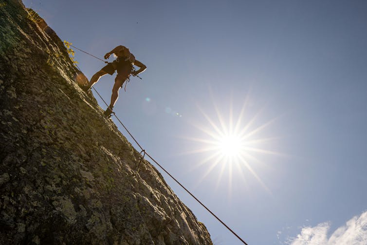 Man climbing during summer.