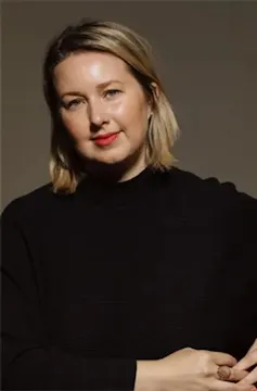 Smiling blonde woman in black