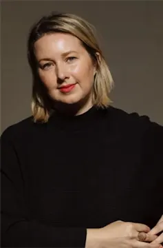 Smiling blonde woman in black