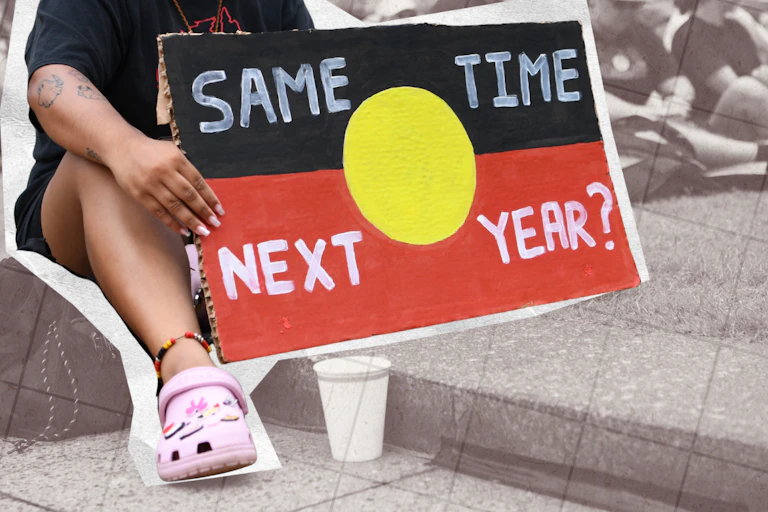 Supporters at an Invasion Day rally with a sign saying 'Same time next year?' in Brisbane, January 26, 2025.