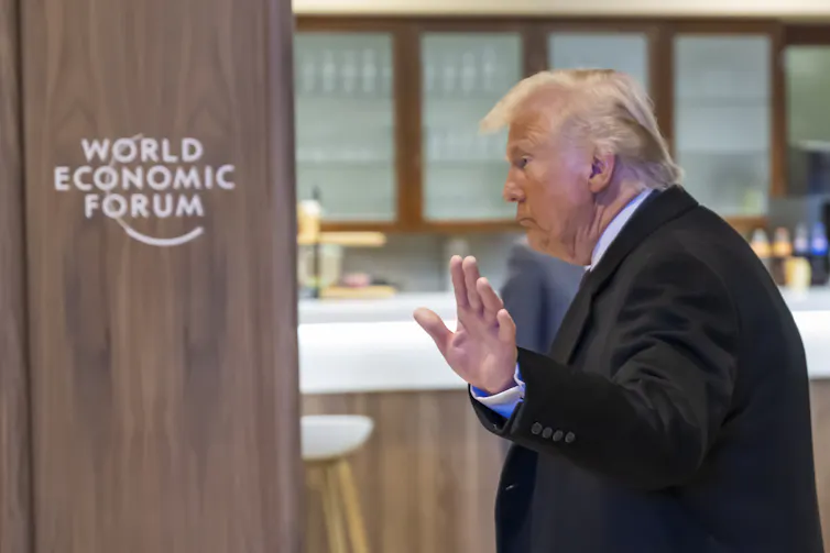 Side view of Trump waving as he leaves the World Economic Forum