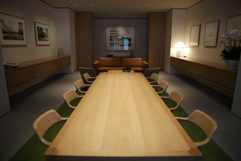 A picture of an empty room with a long table.