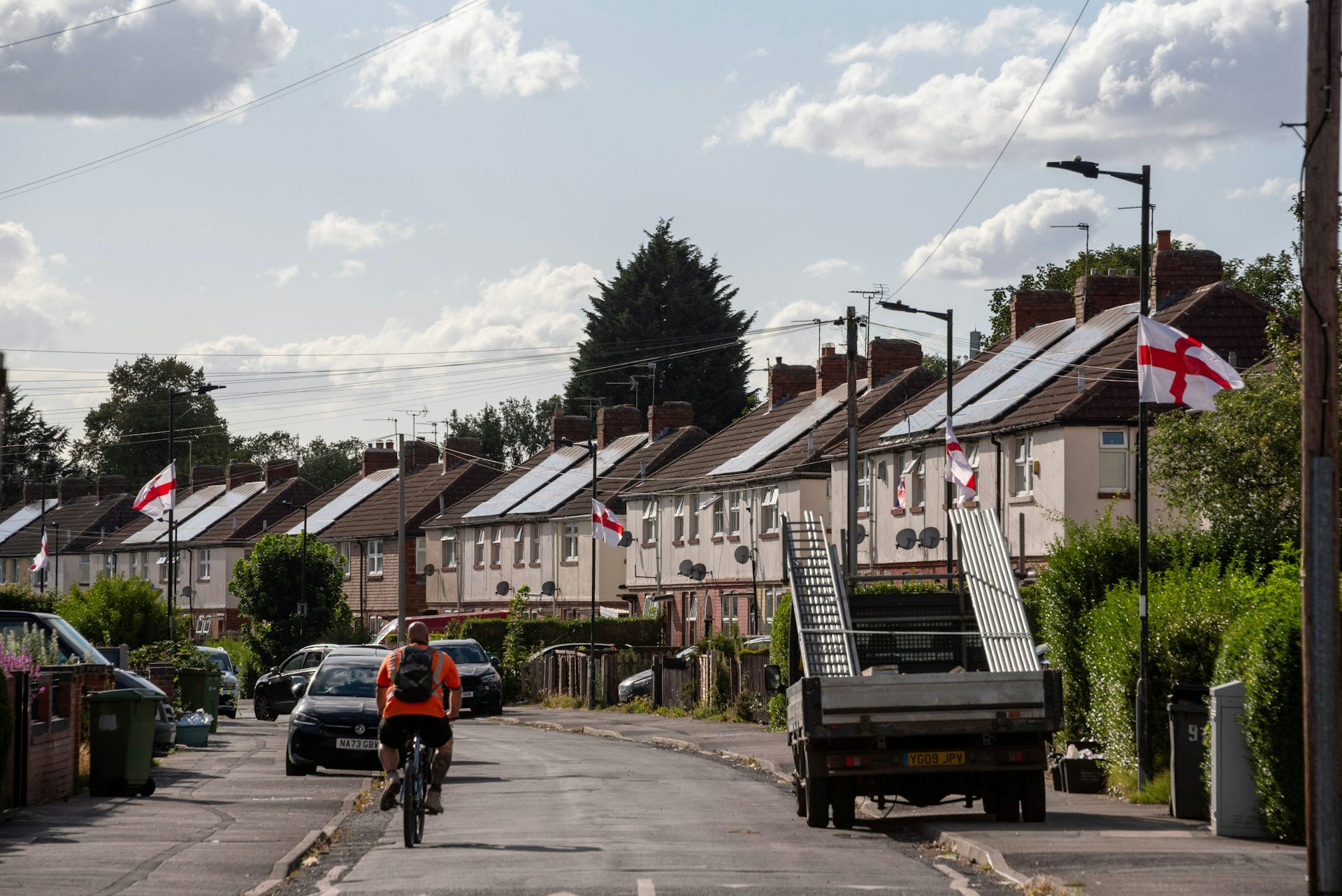 A street adorned with English and UK flags.