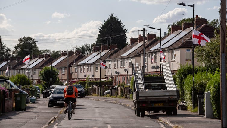 A street adorned with English and UK flags.