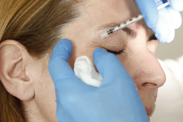 A woman gets a Botox injection.