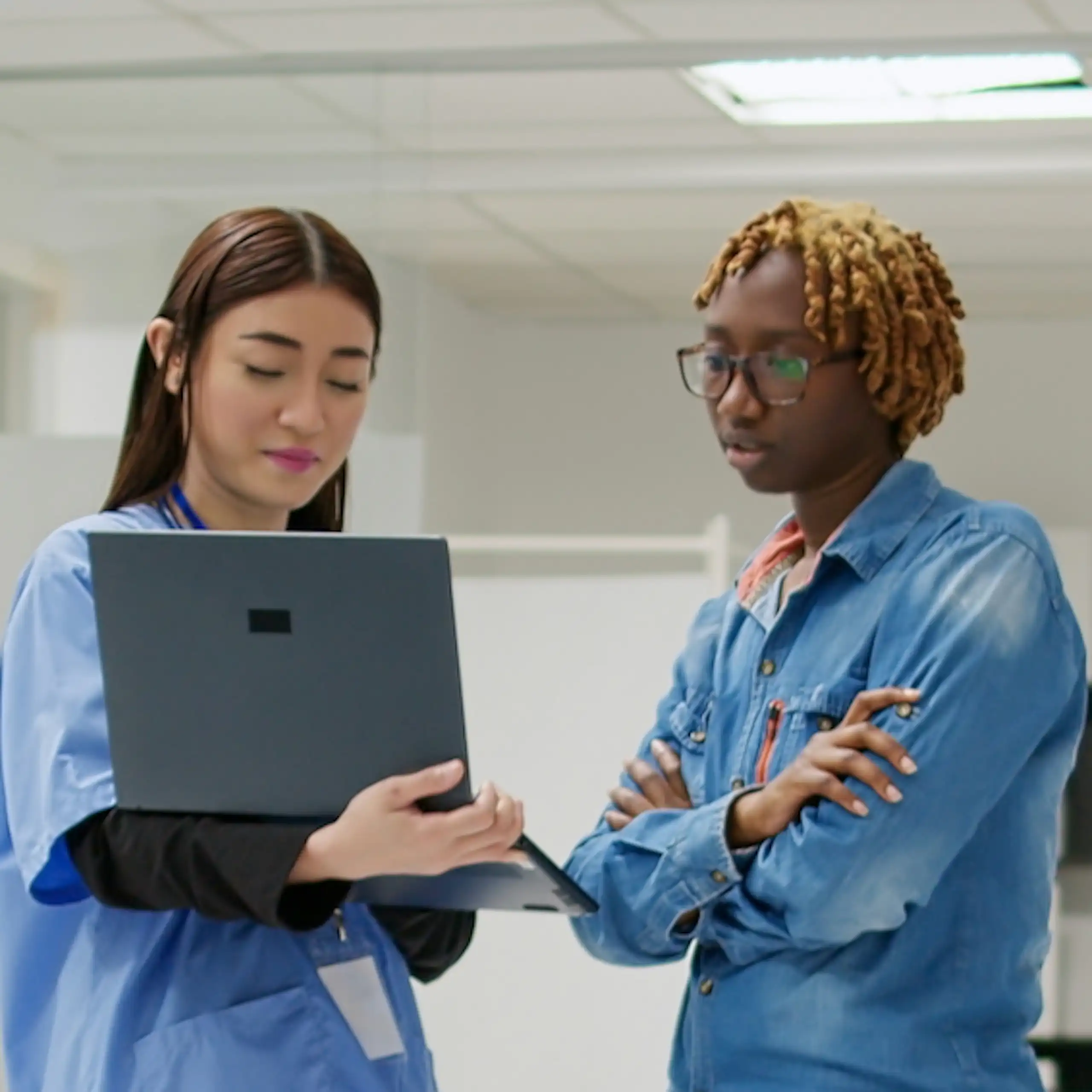 A health-care provider and a patient looking at a laptop screen