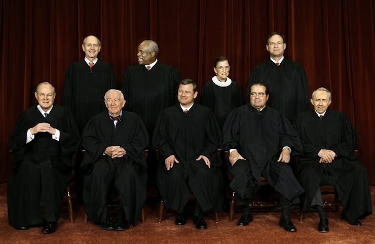 The Supreme Court justices seated for a formal portrait.