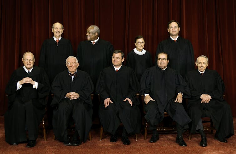 The Supreme Court justices seated for a formal portrait.