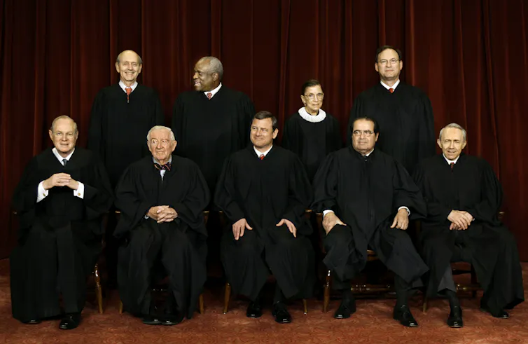 The Supreme Court justices seated for a formal portrait.