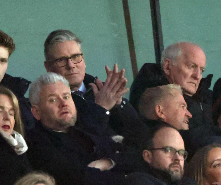 Keir Starmer in the crowd of a footbal stadium.