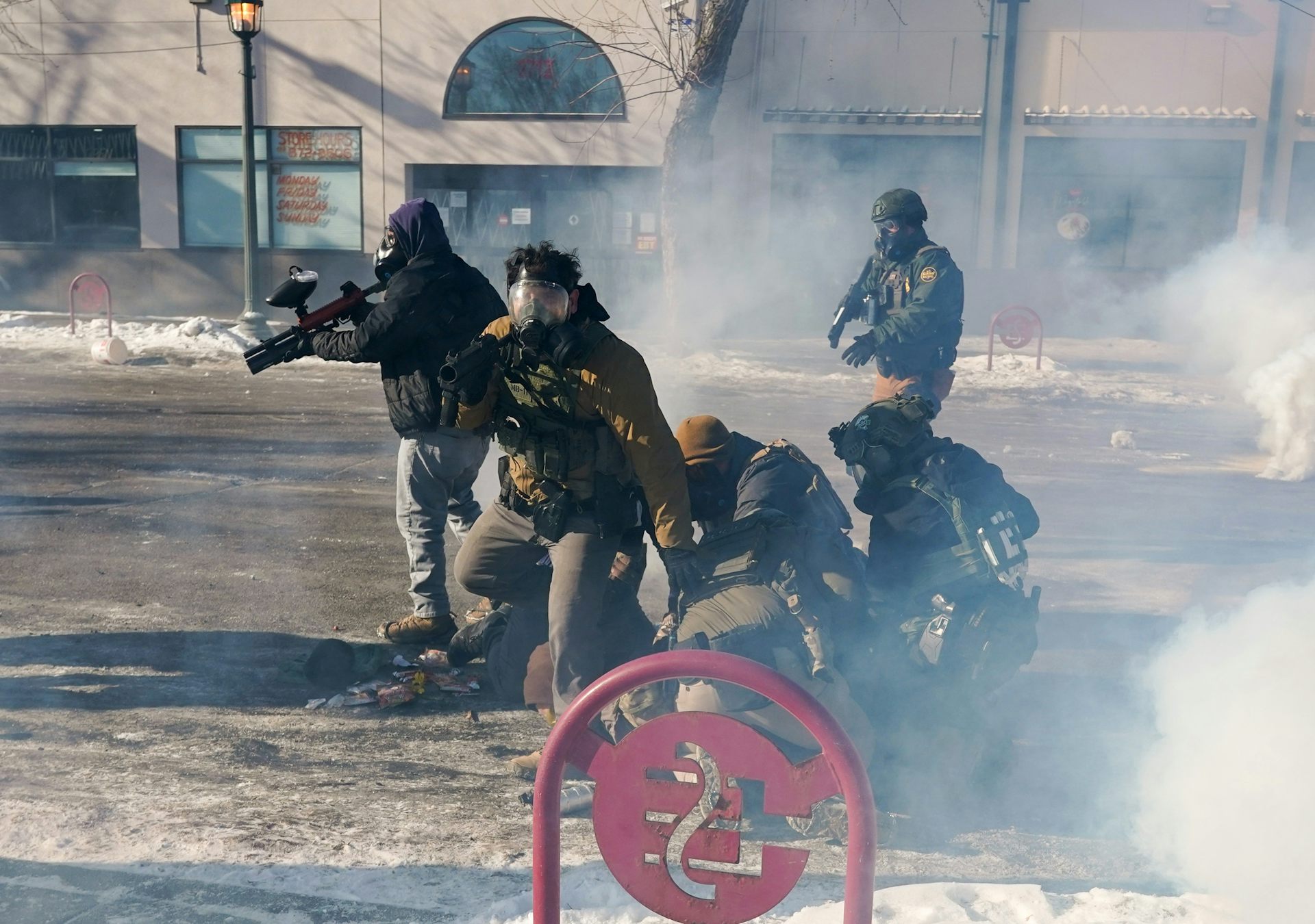 Federal immigration agents (ICE) with firearms and tear-gas guns in Minneapolis, January 2026. 