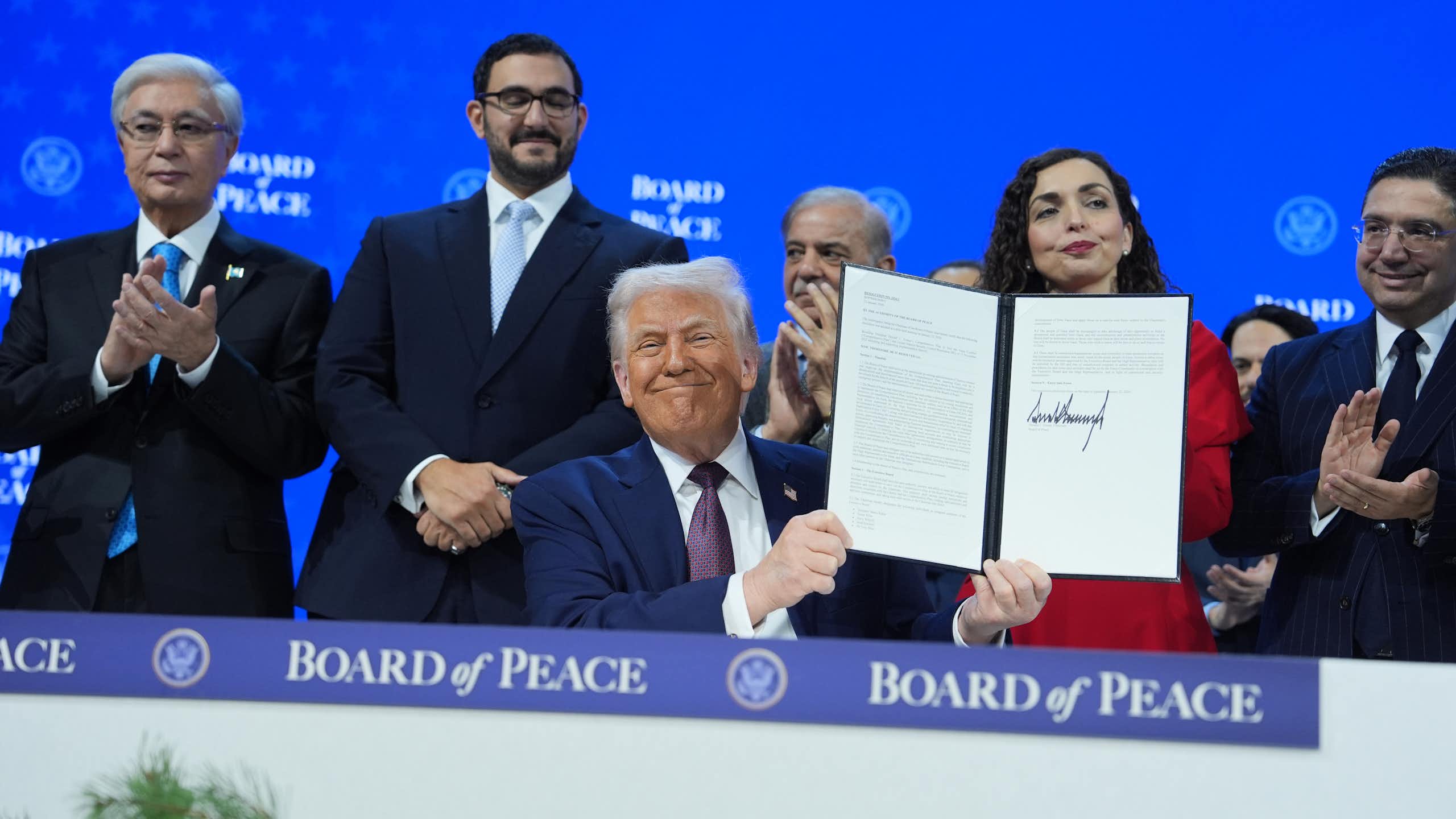 President Trump holds up a document he's signed regarding the formation of an international Board of Peace.