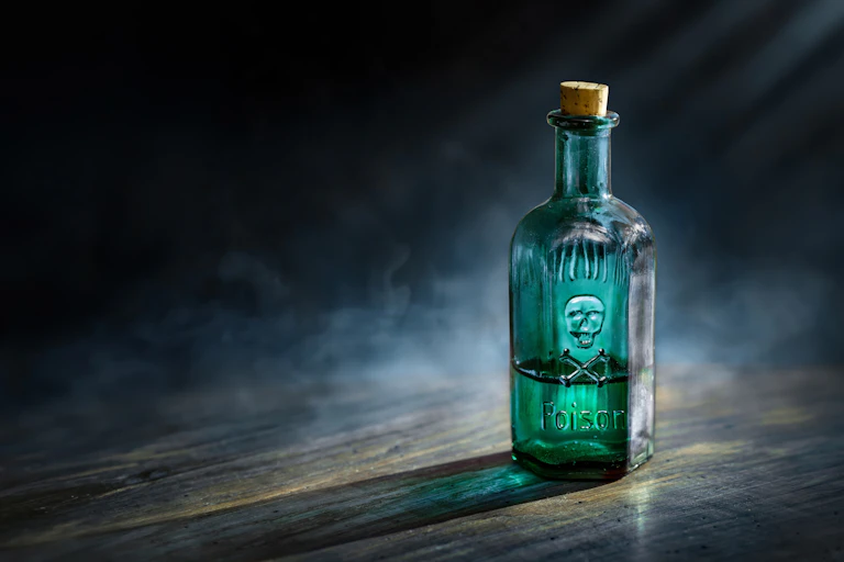 Small green glass poison bottle