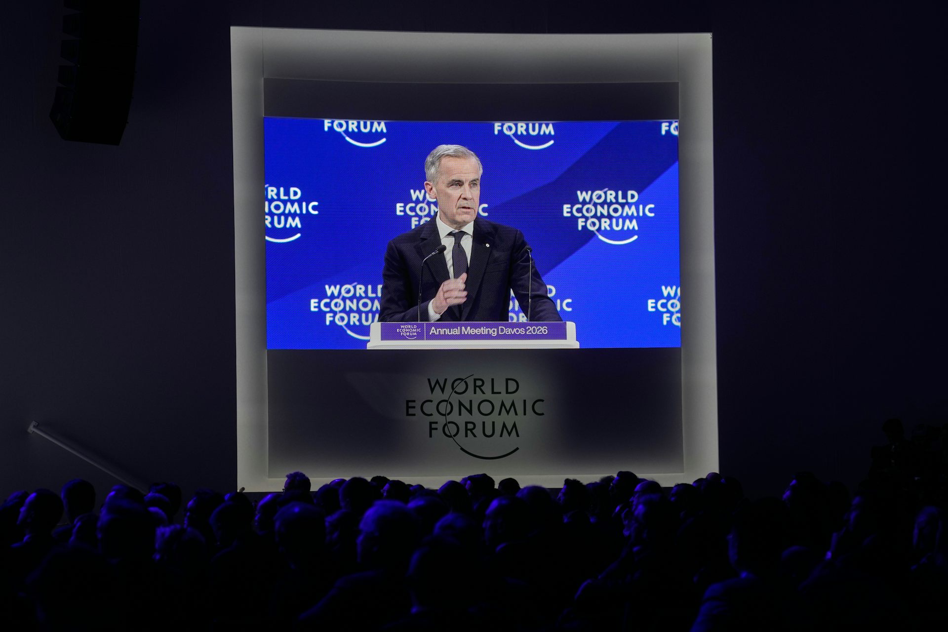 A video screen shows Canadian Prime Minister Mark Carney as he addresses the audience at Davos.