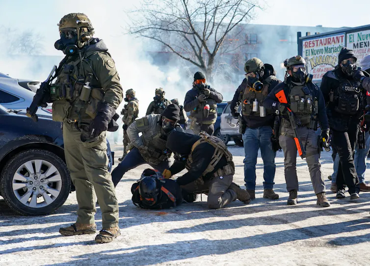 Federal officers detain a protester in Minneapolis.