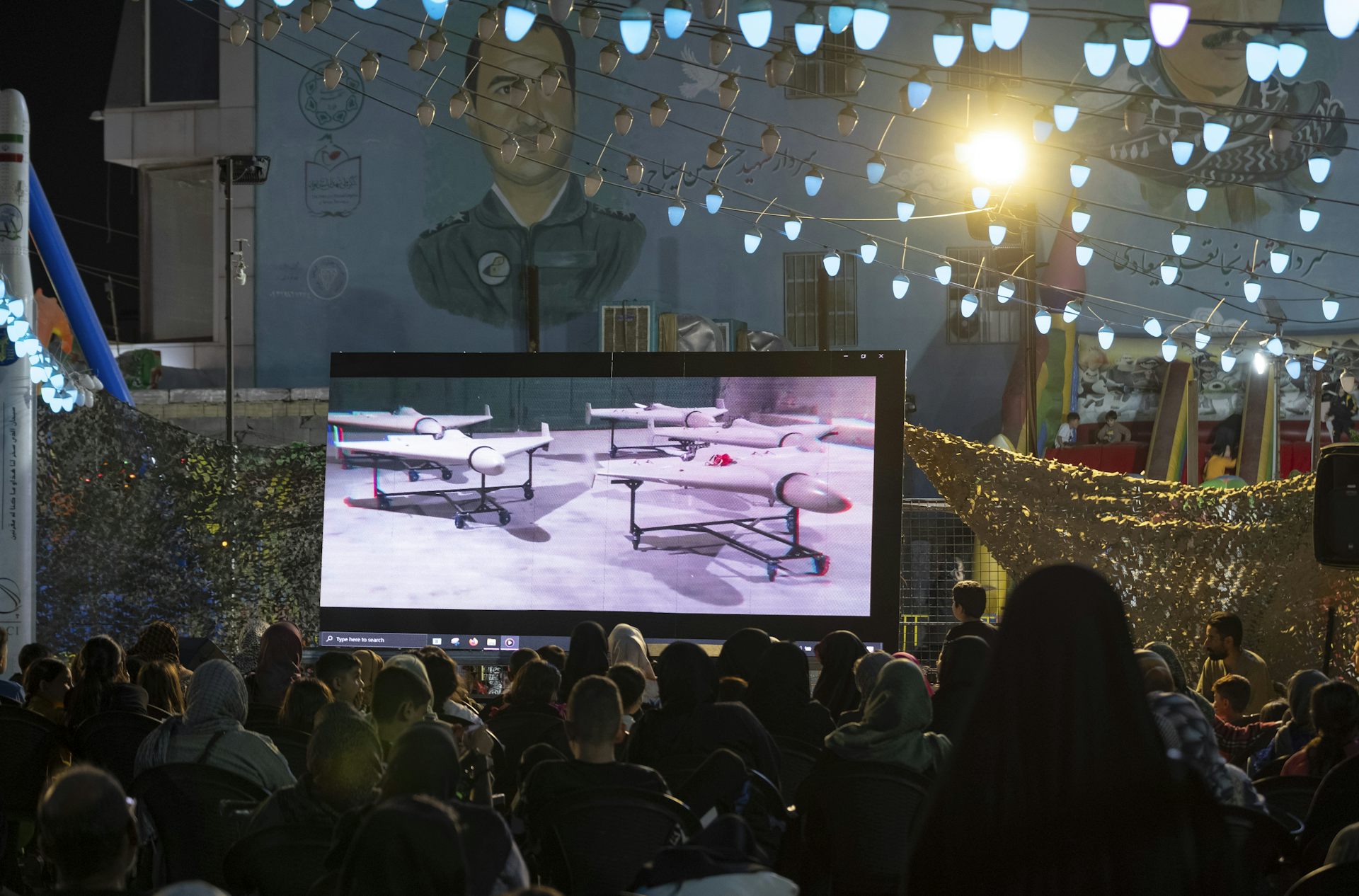 A screen shows flying vehicles.