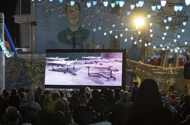 A screen shows flying vehicles.