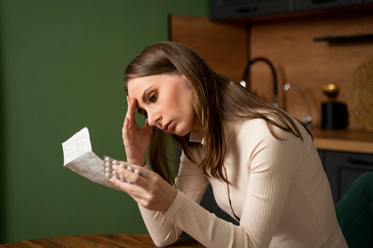 When On a regular basis Drugs Make Us Ill: Misuse and Aspect Results 2 A woman reads the instructions on the medicine package she is holding in her hand