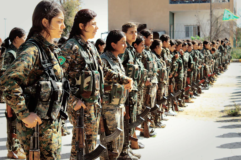 Kurdish fighters of the all-female Women Protection Units (YPJ) stand in formation.