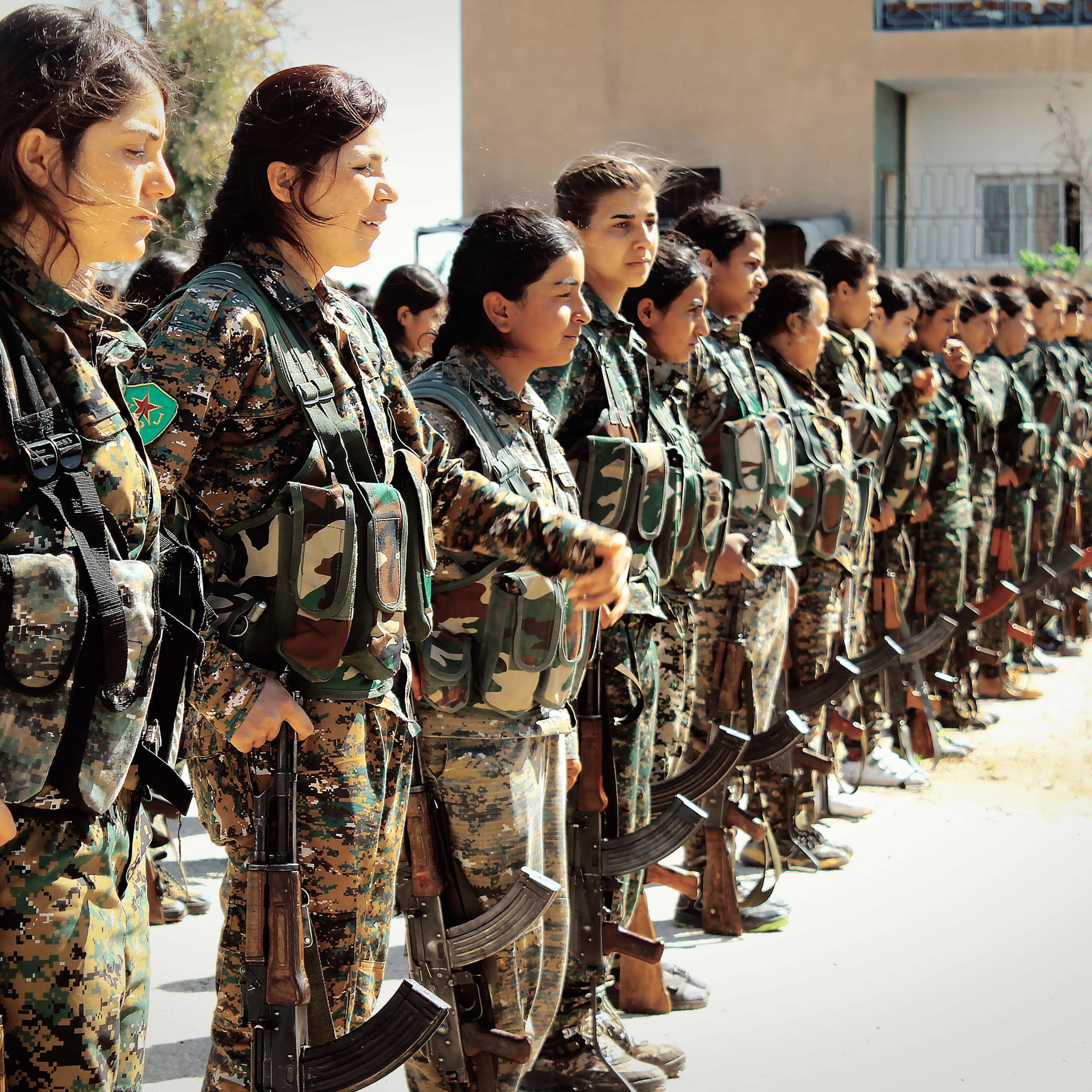 Kurdish fighters of the all-female Women Protection Units (YPJ) stand in formation.