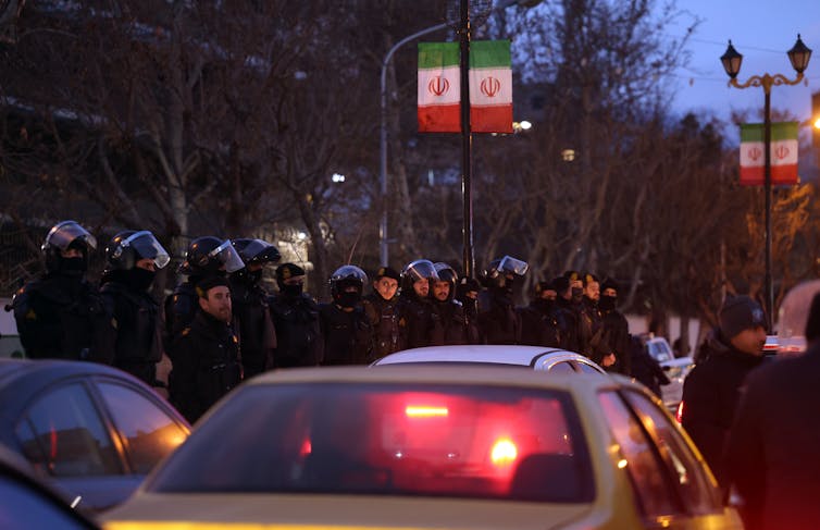 Iranian riot police stand guard in front of the British embassy in Tehran.