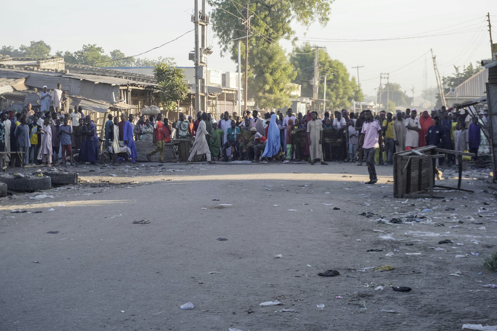 People stand in a street.