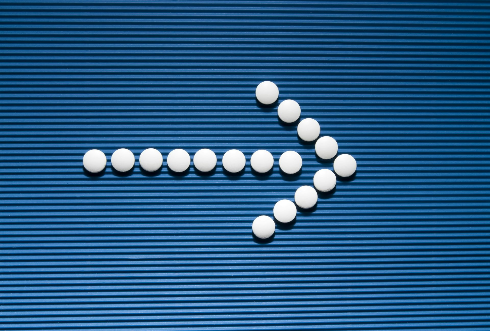 White tablets forming an arrow