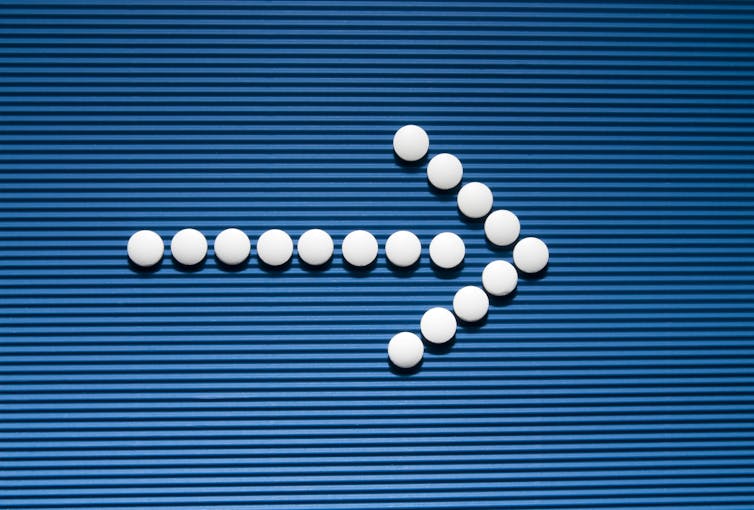 White tablets forming an arrow