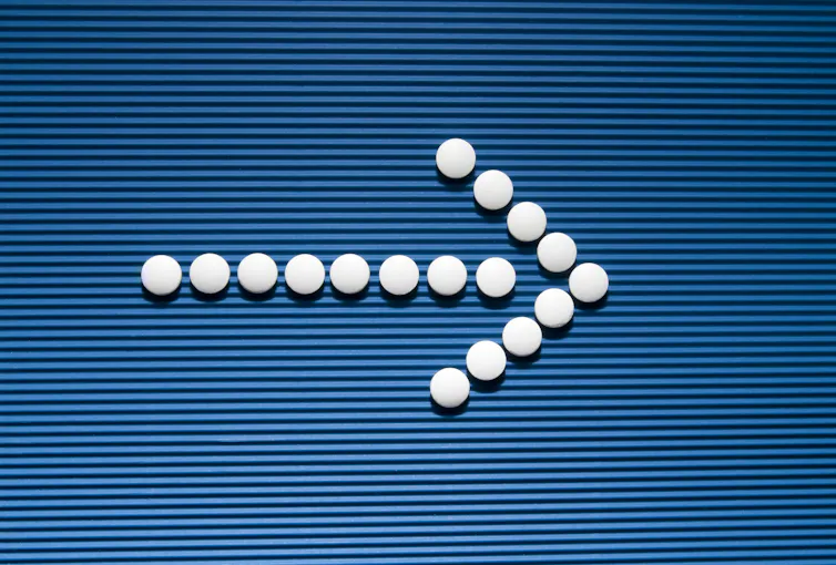 White tablets forming an arrow
