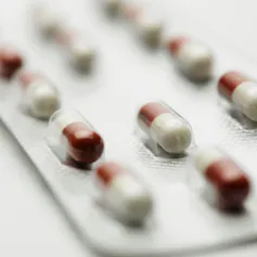 A blister pack of red and white capsules