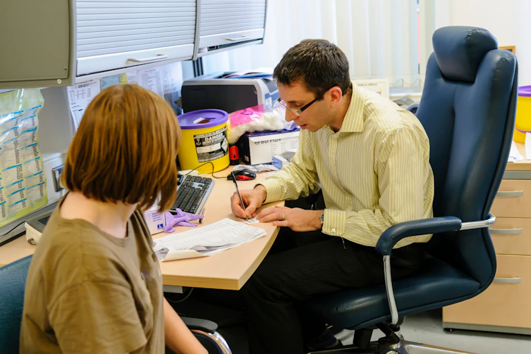 Doctor and patient in a consulting room at a GP surgery