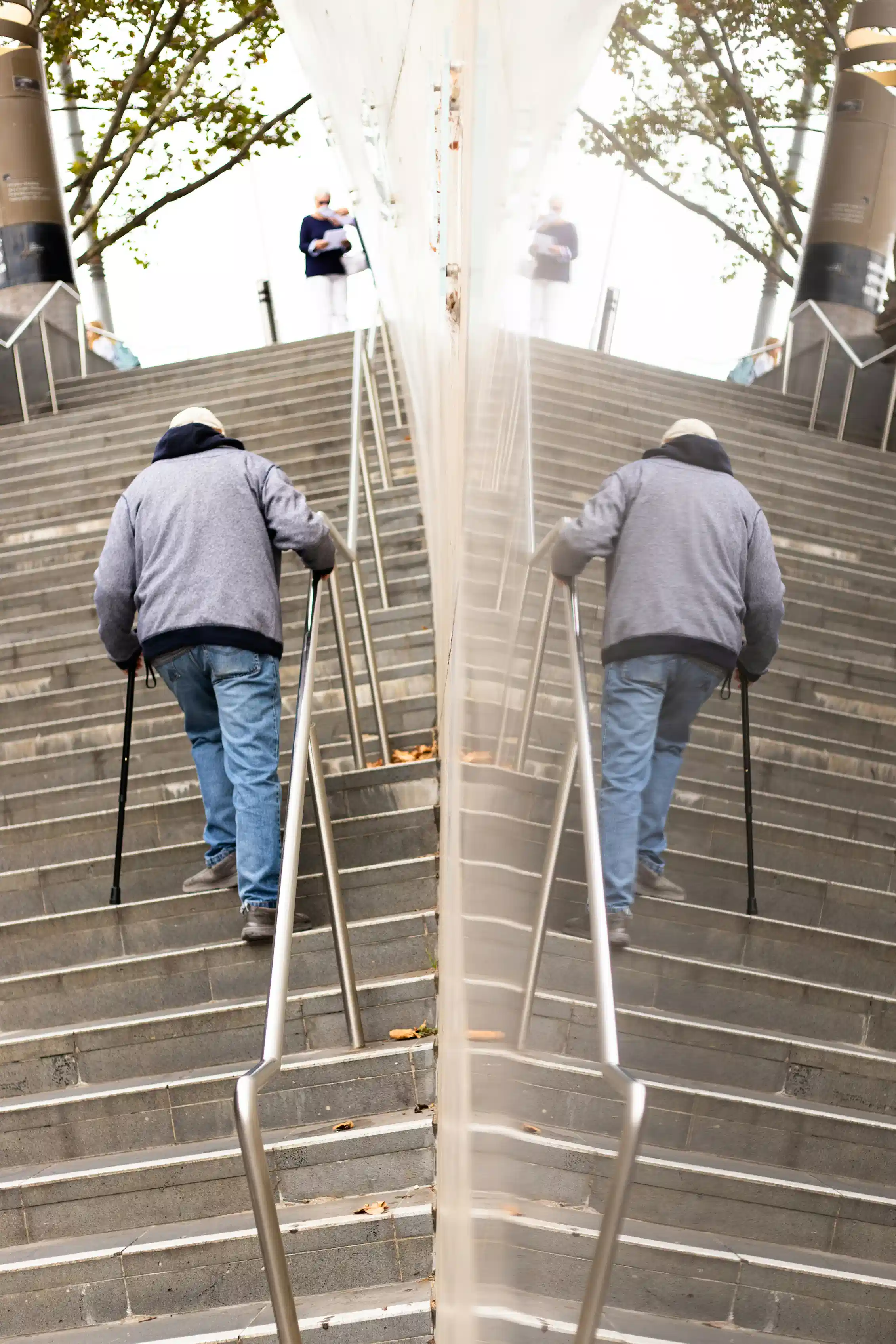 An elderly man climbing stairs
