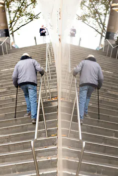 An elderly man climbing stairs