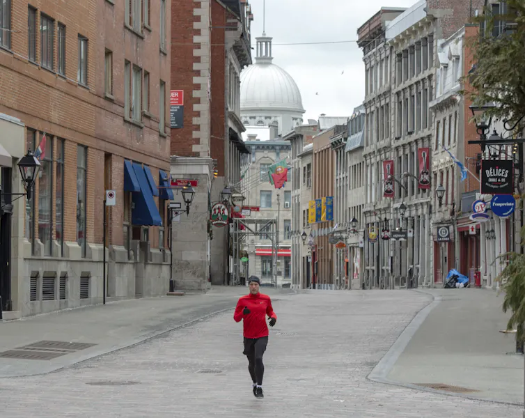 A jogger runs through empty streets
