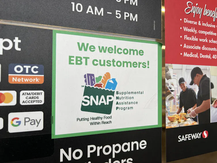 A supermarket sign welcomes SNAP customers.