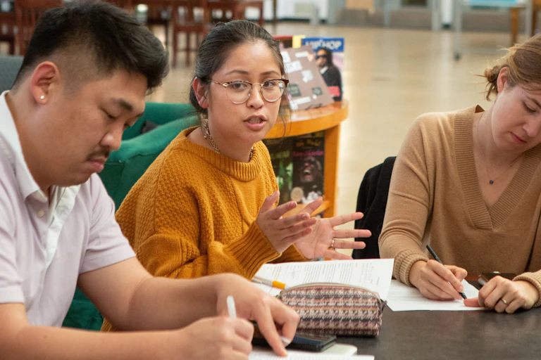 People sitting at a table in discussion.