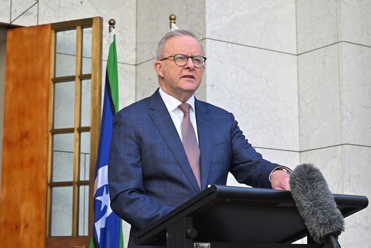 Anthony Albanese stands at a lectern and speaks