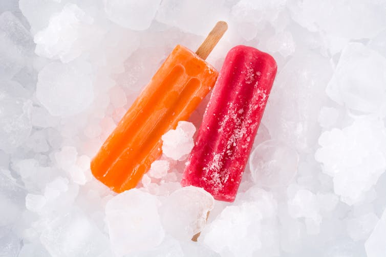 Two ice lollies on a bed of ice.