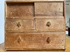 A small wooden chest of drawers.