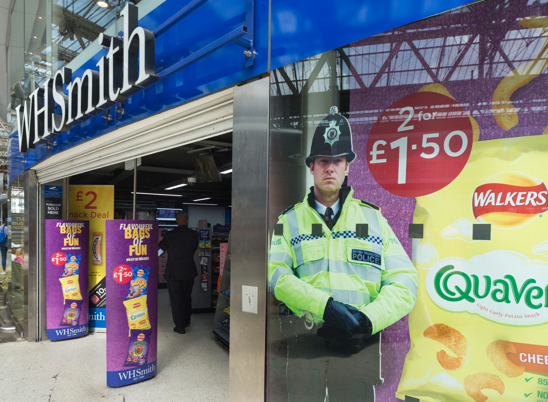 A cardboard cut-out of a police officer in the window of a WHSmith