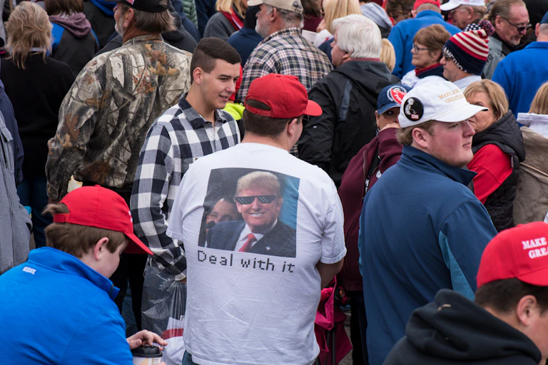 Man wearing a meme t-shirt with Donald trump on it.