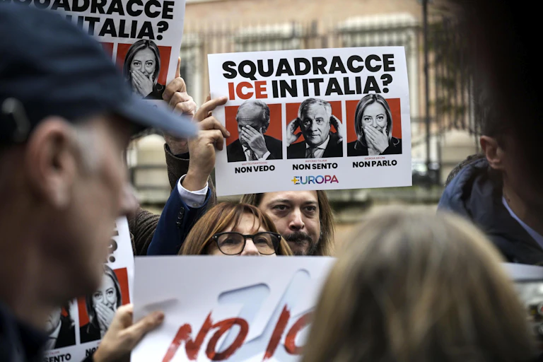 Italians holdng up banners protesting about US plans to use ICE agents as part of their security team at the Winter Olympics in Milan.
