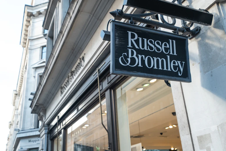 russell & bromley sign hanging on a storefront.